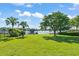 Spacious, well-manicured lawn with mature trees and lake view with private dock at 2922 Carmia Dr, Orlando, FL 32806