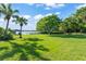 Large grassy backyard with lake access and mature trees at 2922 Carmia Dr, Orlando, FL 32806