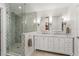 Bright bathroom showcasing dual sink vanity, marble counters, and luxurious walk-in shower with decorative tile at 2922 Carmia Dr, Orlando, FL 32806