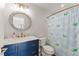 Charming bathroom featuring a modern vanity, round mirror and whimsical shower curtain at 2922 Carmia Dr, Orlando, FL 32806