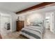 Cozy bedroom with gray and white bedding, wood floors, and exposed beam at 2922 Carmia Dr, Orlando, FL 32806