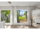 A bright bedroom boasts a large picture window with a view of lush landscaping at 2922 Carmia Dr, Orlando, FL 32806