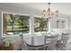 Cozy dining area with views of the private pool, lanai, and lake at 2922 Carmia Dr, Orlando, FL 32806