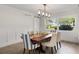 Dining room featuring wood floors, modern chandelier, and large windows at 2922 Carmia Dr, Orlando, FL 32806