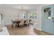Dining room with wood floors, wainscotting, sliding barn door, and blue entry door at 2922 Carmia Dr, Orlando, FL 32806
