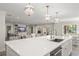 Bright and spacious kitchen featuring a large quartz island and modern pendant lighting at 2922 Carmia Dr, Orlando, FL 32806