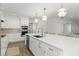 Modern white kitchen featuring stainless steel appliances, quartz countertops, and sleek cabinetry at 2922 Carmia Dr, Orlando, FL 32806