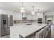 Spacious white kitchen boasting a large island, stainless steel appliances, and stylish bar seating at 2922 Carmia Dr, Orlando, FL 32806