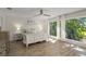 Light and airy main bedroom with floor to ceiling windows and wood floors at 2922 Carmia Dr, Orlando, FL 32806
