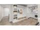 Mud room with built-in storage, hooks, laundry area, and open floor plan to other spaces at 2922 Carmia Dr, Orlando, FL 32806