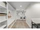 Mud room with built-in storage, a bench, and a laundry area with modern appliances at 2922 Carmia Dr, Orlando, FL 32806