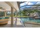 Beautiful screened-in pool area with a water slide, rock feature, and view of the lake at 2922 Carmia Dr, Orlando, FL 32806