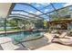 Enclosed pool area features a rock waterfall, lounge chairs, and a covered cabana at 2922 Carmia Dr, Orlando, FL 32806