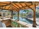 A covered patio area with bar stools overlooks a pool with a rock waterfall feature at 2922 Carmia Dr, Orlando, FL 32806