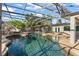 Enclosed pool area with a rock slide, tiki bar, and clear blue water at 2922 Carmia Dr, Orlando, FL 32806