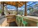 Covered tiki bar with seating overlooks the pool with water slide and covered lanai at 2922 Carmia Dr, Orlando, FL 32806