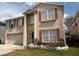 Charming two-story house featuring a well-kept lawn, neutral paint, and classic shutters at 3024 Natoma Way, Orlando, FL 32825