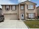 Two-story home featuring an attached two-car garage, small front yard, and neutral color palette at 3024 Natoma Way, Orlando, FL 32825