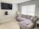 Inviting living room with a comfortable gray couch, tv, and tile floors at 3024 Natoma Way, Orlando, FL 32825