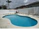 Inviting pool with white concrete surround and white wood fence; perfect for relaxation and outdoor enjoyment at 3024 Natoma Way, Orlando, FL 32825