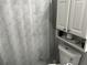 Clean bathroom featuring a white floral shower curtain and coordinating vanity storage at 4251 Pinebark Ave # 17-3, Orlando, FL 32811