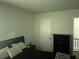 A well-lit room with a black dresser and decorative furnishings and an inviting sleeping space at 4251 Pinebark Ave # 17-3, Orlando, FL 32811