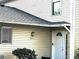 Charming front door with sidelight and address plate, complemented by neutral siding and neat landscaping at 4251 Pinebark Ave # 17-3, Orlando, FL 32811