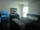 Inviting primary bedroom featuring soft natural light, black furniture and a zebra throw blanket at 4251 Pinebark Ave # 17-3, Orlando, FL 32811