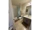 Bathroom with a shower-tub combo, gray cabinets, and tile flooring at 4573 Ada Ln, Kissimmee, FL 34746