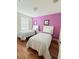 Bedroom with twin beds featuring wood floors, natural light, and neutral decor at 4573 Ada Ln, Kissimmee, FL 34746