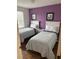 Bedroom featuring two beds, wood floors, natural light, and modern decor at 4573 Ada Ln, Kissimmee, FL 34746