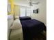Bright bedroom featuring two beds, a ceiling fan, and a wall-mounted television at 4573 Ada Ln, Kissimmee, FL 34746