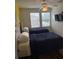 Bedroom with two twin beds, a ceiling fan, natural light, and a mounted TV at 4573 Ada Ln, Kissimmee, FL 34746