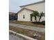 Charming home exterior with stucco walls, red tile roof and green landscaping with mature palms and walkway at 4573 Ada Ln, Kissimmee, FL 34746