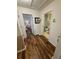 Hallway with wood floors leading to bedroom and bathroom with white trim and neutral wall color at 4573 Ada Ln, Kissimmee, FL 34746