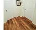 Hallway with wood floors, three doors and overhead lighting at 4573 Ada Ln, Kissimmee, FL 34746