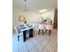 Open concept kitchen & dining area with marble table, breakfast bar, and stylish seating at 4573 Ada Ln, Kissimmee, FL 34746