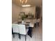 Kitchen and dining area with island, granite countertops, white cabinets, and stainless-steel appliances at 4573 Ada Ln, Kissimmee, FL 34746
