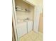 Bright laundry room featuring a washer, dryer, shelving, and tile flooring at 4573 Ada Ln, Kissimmee, FL 34746