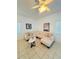 Inviting living room featuring neutral sectional, tile flooring, ceiling fan and soft, natural lighting at 4573 Ada Ln, Kissimmee, FL 34746