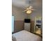 Main bedroom with access to bathroom. Features ceiling fan and wood-look floors at 4573 Ada Ln, Kissimmee, FL 34746