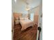 Well-lit main bedroom with a bed, ceiling fan, and beautiful vinyl flooring at 4573 Ada Ln, Kissimmee, FL 34746