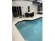 Relaxing backyard pool with patio seating and a sliding glass door, perfect for outdoor living at 4573 Ada Ln, Kissimmee, FL 34746