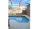 Inviting backyard pool with a sun shelf, screened enclosure, and easy access to outdoor relaxation at 4573 Ada Ln, Kissimmee, FL 34746