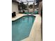 Gorgeous backyard pool area with lounge chairs, curtains and screened enclosure for outdoor enjoyment at 4573 Ada Ln, Kissimmee, FL 34746