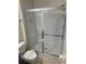 Bathroom featuring shower, toilet, and towel rack with a neutral tile floor at 4573 Ada Ln, Kissimmee, FL 34746
