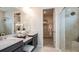 Bright bathroom featuring double sinks, a walk-in shower, and access to a closet at 4711 Coral Harbour Rd, Kissimmee, FL 34758