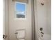Bathroom with a toilet, bathtub, and shower with patterned curtains at 4711 Coral Harbour Rd, Kissimmee, FL 34758