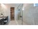 Modern bathroom with a glass-enclosed shower and tiled walls at 4711 Coral Harbour Rd, Kissimmee, FL 34758