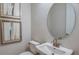 Bathroom with sink and decorative framed artwork above the toilet at 4711 Coral Harbour Rd, Kissimmee, FL 34758